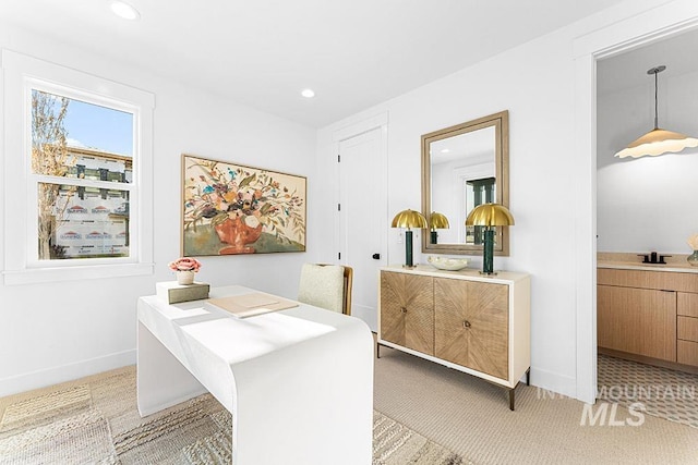 office space with light colored carpet, recessed lighting, baseboards, and a sink