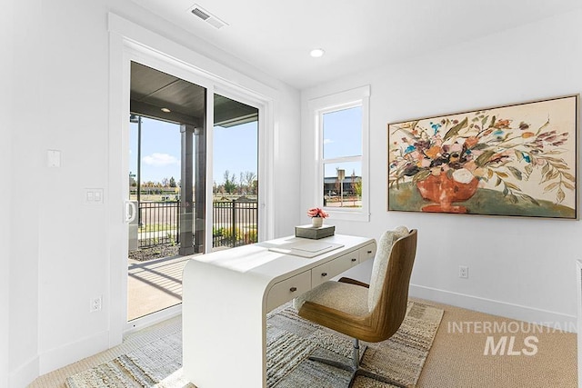 carpeted office space with baseboards and recessed lighting
