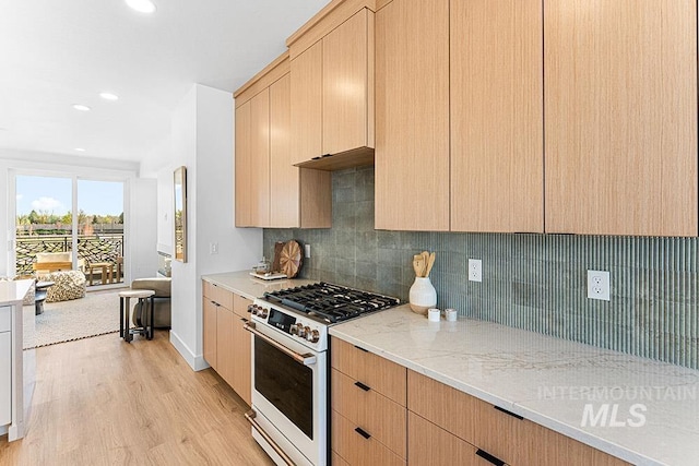 kitchen featuring gas range gas stove, light brown cabinetry, light wood-style floors, backsplash, and recessed lighting
