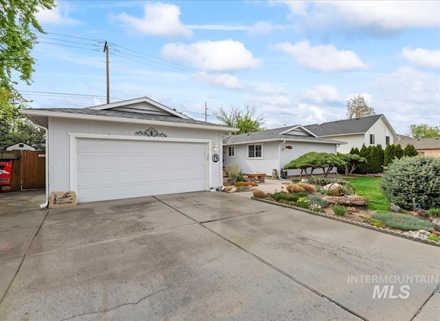 ranch-style home with fence and driveway
