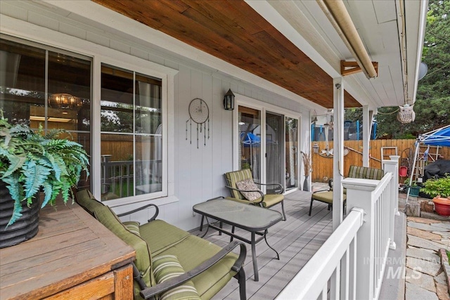view of patio / terrace with a porch, fence, and area for grilling