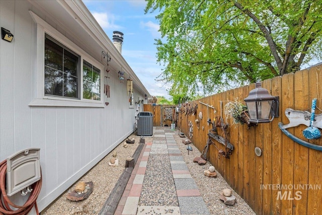 view of side of home with a fenced backyard and cooling unit