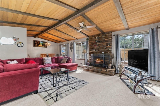 living area featuring ceiling fan, lofted ceiling with beams, a fireplace, carpet, and wood ceiling
