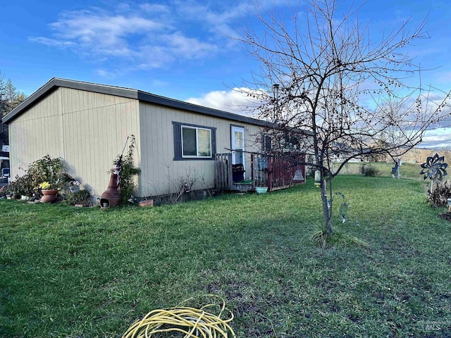 view of property exterior with a lawn