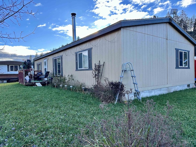 view of side of home with a yard