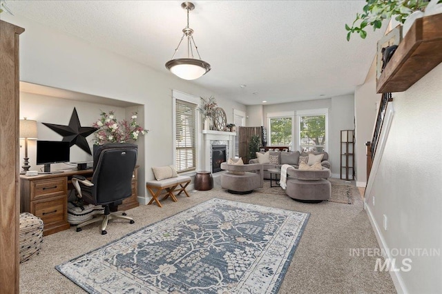 carpeted home office featuring a textured ceiling and a high end fireplace