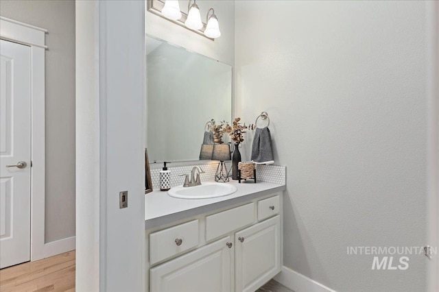 bathroom with hardwood / wood-style floors and vanity