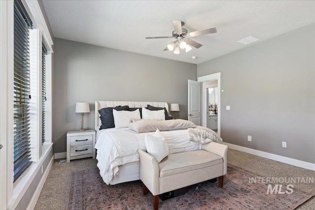 carpeted bedroom with a textured ceiling and ceiling fan