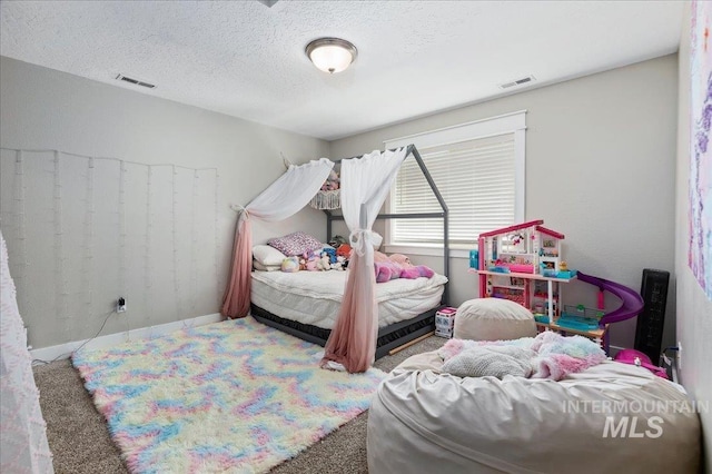 carpeted bedroom featuring a textured ceiling