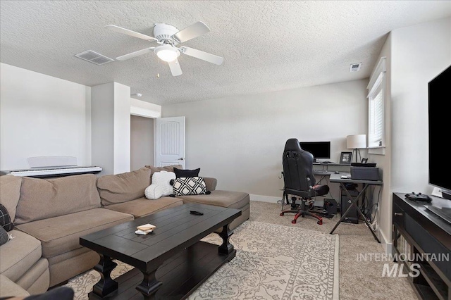 living room featuring a textured ceiling and ceiling fan