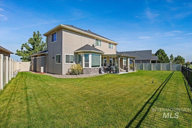 back of property with a lawn and a patio area