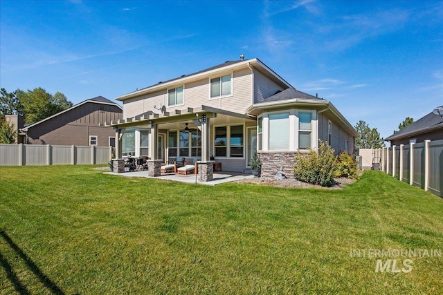 back of property featuring an outdoor living space, ceiling fan, a yard, and a patio