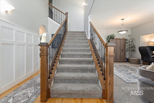 staircase with hardwood / wood-style flooring