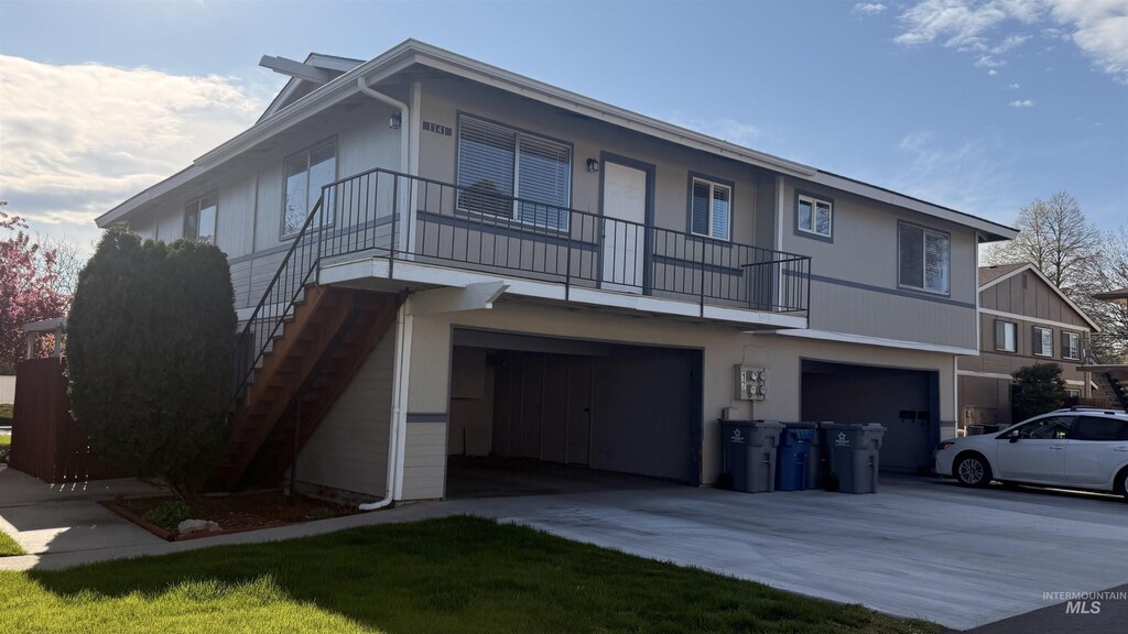 1141 S Hilton St, Boise, ID 83705 - view of front of home with stairway, concrete driveway, and a garage