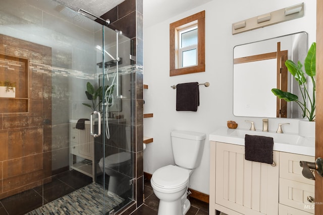 2036 N Blaine Way, Boise, ID 83702 - full bathroom with toilet, a shower stall, vanity, tile patterned flooring, and baseboards