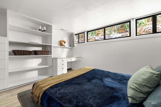 2036 N Blaine Way, Boise, ID 83702 - bedroom featuring multiple windows, wood finished floors, and a textured ceiling