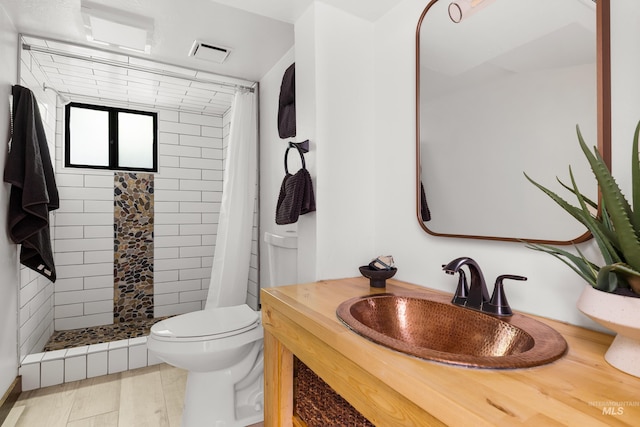 2036 N Blaine Way, Boise, ID 83702 - bathroom with toilet, a tile shower, vanity, and wood finished floors