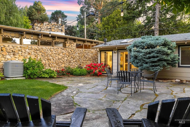 2036 N Blaine Way, Boise, ID 83702 - patio terrace at dusk featuring central AC, a patio area, and outdoor dining space