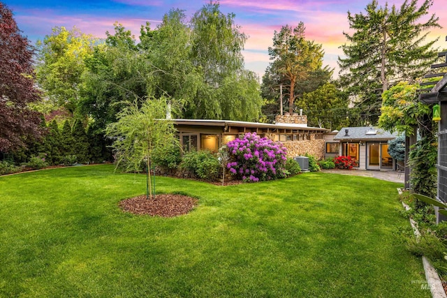 2036 N Blaine Way, Boise, ID 83702 - yard at dusk featuring a lawn and central AC