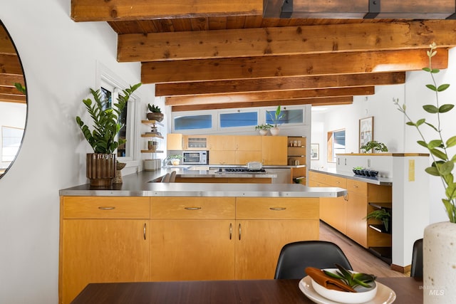 2036 N Blaine Way, Boise, ID 83702 - kitchen with stainless steel counters, beamed ceiling, light brown cabinetry, stainless steel gas cooktop, and open shelves