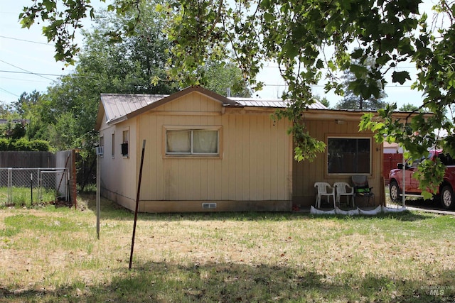 view of property exterior featuring a lawn