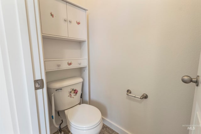 bathroom featuring tile patterned flooring and toilet