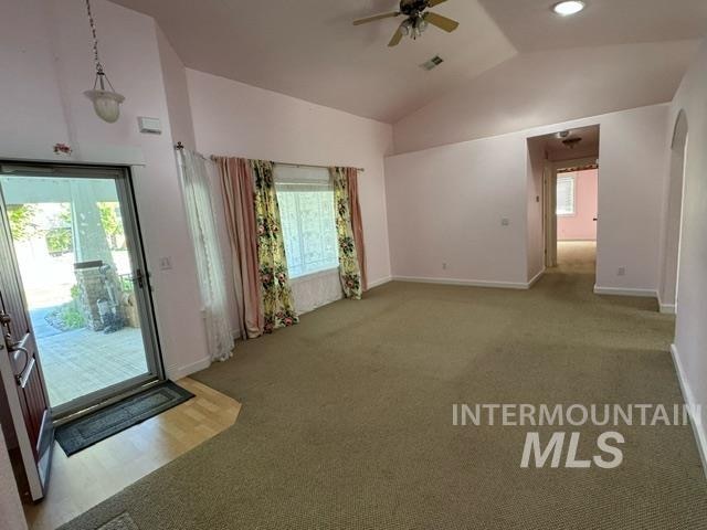 interior space featuring carpet flooring, lofted ceiling, and ceiling fan