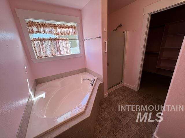 bathroom featuring separate shower and tub