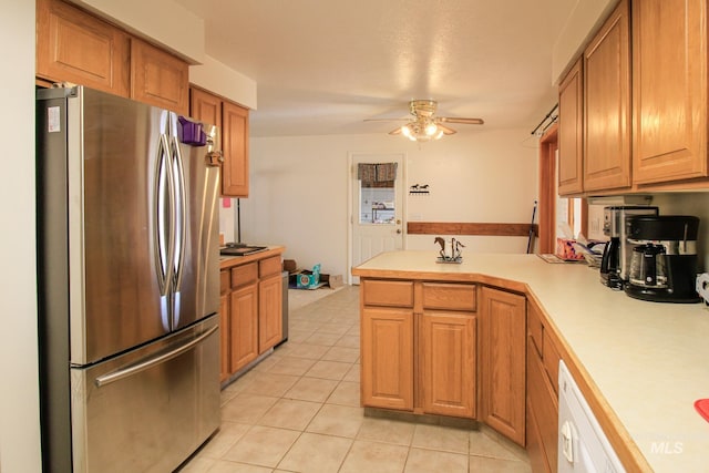 kitchen with kitchen peninsula, stainless steel fridge, ceiling fan, light tile patterned floors, and dishwasher