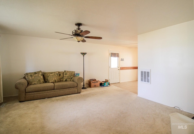 carpeted living room featuring ceiling fan