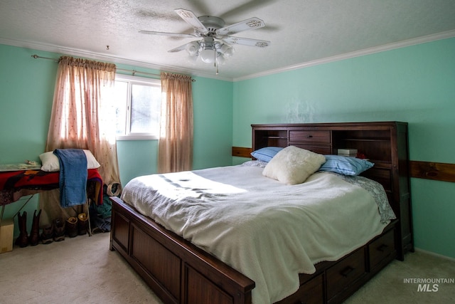 carpeted bedroom featuring ceiling fan, crown molding, and a textured ceiling