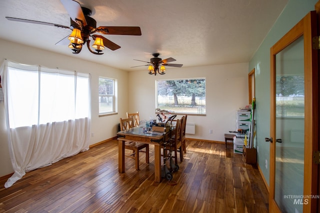 dining space featuring ceiling fan and dark wood-type flooring