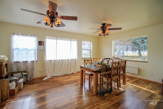 dining space with hardwood / wood-style flooring and ceiling fan
