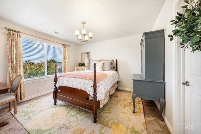 bedroom with carpet floors and an inviting chandelier