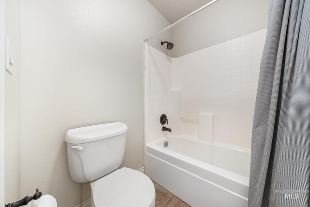 bathroom with toilet and shower / tub combo