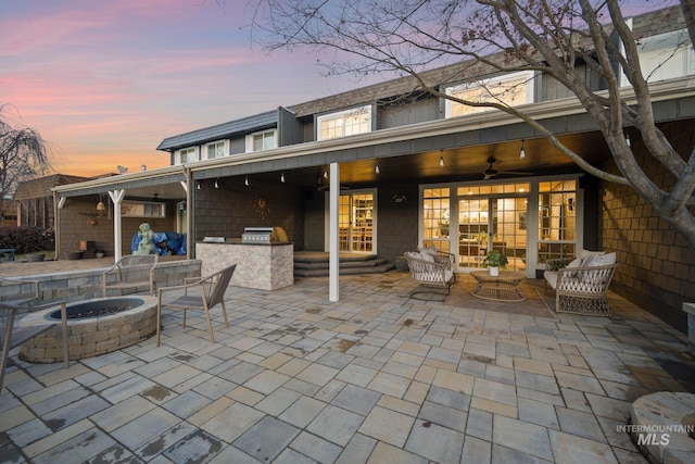 view of patio with a ceiling fan, an outdoor fire pit, and area for grilling