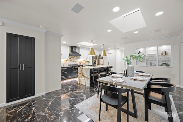 dining room with a skylight, marble finish floor, crown molding, recessed lighting, and baseboards