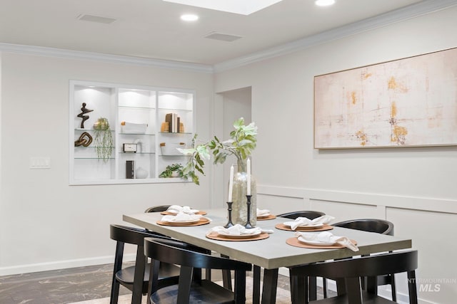 dining space featuring recessed lighting, a wainscoted wall, and crown molding