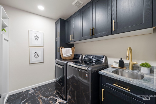 clothes washing area with a sink, baseboards, marble finish floor, independent washer and dryer, and cabinet space