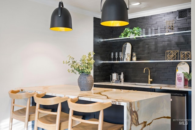 bar featuring tasteful backsplash, wet bar, ornamental molding, and a sink