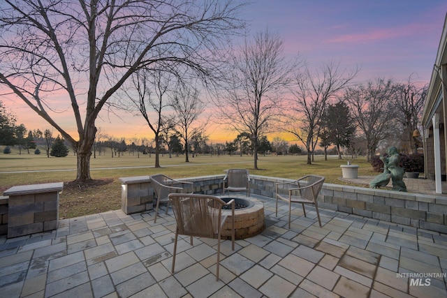 view of patio / terrace featuring an outdoor fire pit