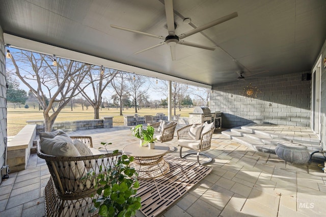 view of patio with exterior kitchen, outdoor dining space, outdoor lounge area, and ceiling fan