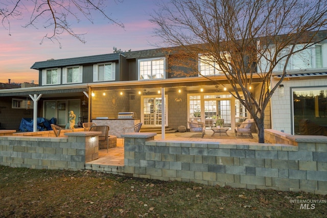 rear view of property with a patio, french doors, and exterior bar