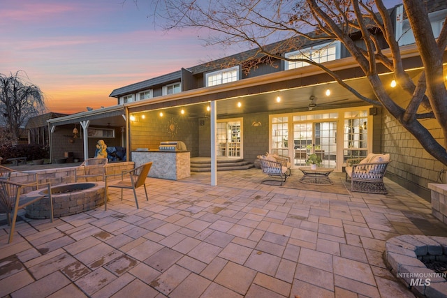 patio terrace at dusk with french doors and a fire pit