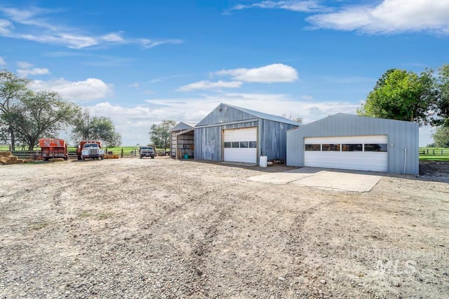 view of front of home with an outdoor structure and a garage