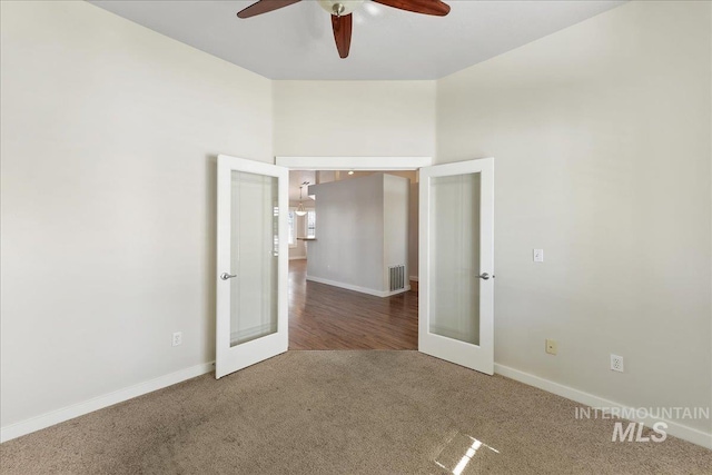 unfurnished bedroom featuring carpet floors, a ceiling fan, visible vents, baseboards, and french doors