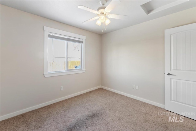 empty room featuring carpet, ceiling fan, and baseboards