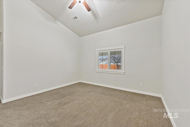 carpeted spare room with ceiling fan, a textured ceiling, visible vents, baseboards, and vaulted ceiling