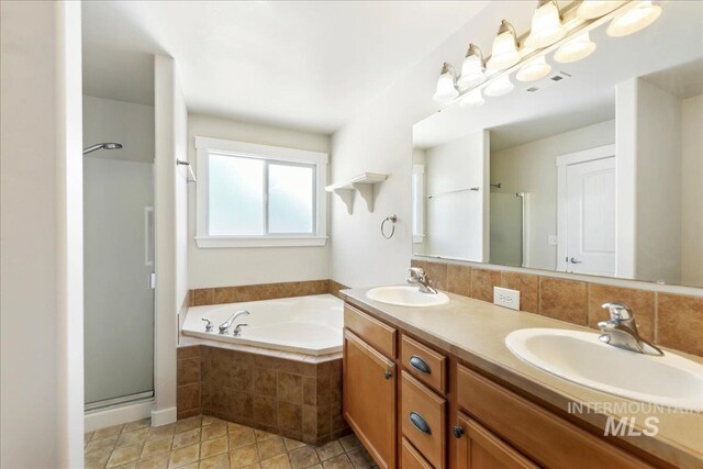 bathroom with tasteful backsplash, a sink, and a shower stall