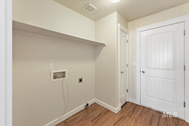 laundry area featuring hookup for a washing machine, visible vents, hookup for an electric dryer, and wood finished floors